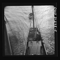 [Untitled photo, possibly related to: On board the fishing boat Alden out of Gloucester, Massachusetts. A scene at sea showing the mother ship towing a small dory]. Sourced from the Library of Congress.