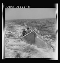 On board the fishing boat Alden, out of Gloucester, Massachusetts. A dory with men, being towed during a mackerel chase. Sourced from the Library of Congress.