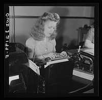 Washington, D.C. Miss Kathleen McCarthy, a Western Union teleprinter operator, receiving gumming telegraph messages. Sourced from the Library of Congress.