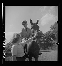 Oswego, New York. Polish naval officer riding a horse at a farm where the heroes were entertained during United Nations week. Sourced from the Library of Congress.