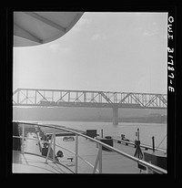 [Untitled photo, possibly related to: Cincinnati (vicinity), Ohio. A bridge over the Ohio River, as seen from the towboat Ernest T. Weir]. Sourced from the Library of Congress.