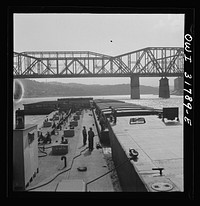Cincinnati (vicinity), Ohio. Deckhands releasing a barge from the tow of the towboat Ernest T. Weir going down the Ohio River. Sourced from the Library of Congress.