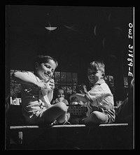 New Britain, Connecticut. A child care center, opened September 15, 1942, for thirty children, age two to five, of mothers engaged in war industry. The hours are 6:30 a.m. to 6 p.m. six days per week. "Milk time" at the center. Sourced from the Library of Congress.