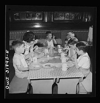 New Britain, Connecticut. A child care center, opened September 15, 1942, for thirty children, aged two to five, of mothers engaged in war industry. The hours are 6:30 a.m. to 6 p.m., six days per week. Children having lunch with a trained assistant. Sourced from the Library of Congress.