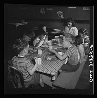 New Britain, Connecticut. A child care center, opened September 15, 1942, for thirty children, aged two to five, of mothers engaged in war industry. The hours are 6:30 a.m. to 6 p.m., six days per week. Children having lunch with a trained assistant. Sourced from the Library of Congress.