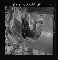 Bar Harbor, Maine. Civil Air Patrol base headquarters of coastal patrol no. 20. Ground crew mechanic making repairs on a patrol plane in the hangar. Sourced from the Library of Congress.