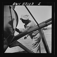 [Untitled photo, possibly related to: Bar Harbor, Maine. Civil Air Patrol base headquarters of coastal patrol no. 20. The chief engineering officer conducting a routine check of patrol planes in the hanger]. Sourced from the Library of Congress.