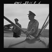 [Untitled photo, possibly related to: Bar Harbor, Maine. Civil Air Patrol base headquarters of coastal patrol no. 20. The chief engineering officer conducting a routine check of patrol planes in the hanger]. Sourced from the Library of Congress.