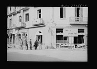 [Untitled photo, possibly related to: Sousse, Tunisia. Archbiship Spellman of New York and flyers of the US Army 9th airforce, touring the street to inspect bomb damage]. Sourced from the Library of Congress.