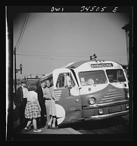 [Untitled photo, possibly related to: Oswego, New York. Boarding a Syracuse bus on Bridge Street]. Sourced from the Library of Congress.