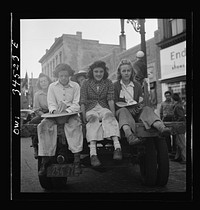 Oswego, New York. Children, recruited for farm work during the summer, waiting to start for work outside the U.S. Employment Service. Sourced from the Library of Congress.