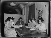 Newport News, Virginia. Mrs. Ethel R. Stephens, organizer of the Consumer Interest Council, a group of  housewives at Newport News, making a report to the members of the Special Services Section of the Office of Price Administration, concerning point rationing. Left to right: Mrs. M. Barr, Miss A. Wilson, Miss Freedman, Mrs. Ethel Stephens, Miss Warrick, and Miss F. Williams. Sourced from the Library of Congress.