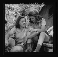 [Untitled photo, possibly related to: Turkey Pond, near Concord, New Hampshire. Women workers employed by U.S. Department of Agriculture timber salvage sawmill. Ruth DeRoche and Norma Webber, eighteen year old "pit-women," relaxing after lunch]. Sourced from the Library of Congress.