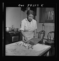 New Britain, Connecticut. A child care center opened September 15, 1942, for thirty children, ages two through five of mothers engaged in war industry. The hours are 6:30 a.m. to 6 p.m. six days per week. The dietician baking cookies. Sourced from the Library of Congress.