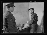 Rockville (vicinity), Maryland. Private Harvey Horton, visiting the N.C. Stiles dairy farm while on furlough from Fort Belvoir, Virginia, talking with Mr. Stiles. Sourced from the Library of Congress.