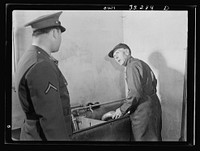 Rockville (vicinity), Maryland. Private Harvey Horton, visiting the N.C. Stiles dairy farm while on furlough from Fort Belvoir, Virginia, talking with Mr. Stiles. Sourced from the Library of Congress.