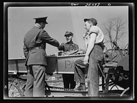 Rockville (vicinity), Maryland. Private Harvey Horton, visiting the N.C. Stiles dairy farm while on furlough from Fort Belvoir, Virginia, being greeted by Mr. N.C. Stiles and his nineteen-year-old son Robert. Sourced from the Library of Congress.