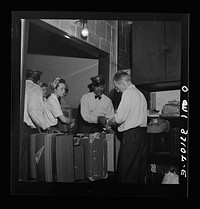 [Untitled photo, possibly related to: Pittsburgh, Pennsylvania. Passengers checking their bags at the Greyhound bus terminal]. Sourced from the Library of Congress.