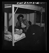 [Untitled photo, possibly related to: Pittsburgh, Pennsylvania. A Greyhound bus driver dressing in dormitory at the garage. This is for the use of drivers living in another town but having their layover time in Pittsburgh]. Sourced from the Library of Congress.