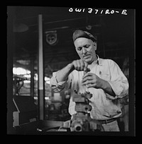 [Untitled photo, possibly related to: Pittsburgh, Pennsylvania. A mechanic in the machine shop at the Greyhound garage]. Sourced from the Library of Congress.