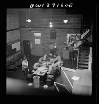 [Untitled photo, possibly related to: Pittsburgh, Pennsylvania. Greyhound bus drivers writing out trip reports in the garage]. Sourced from the Library of Congress.