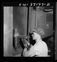 Pittsburgh, Pennsylvania. A mechanic metalizing a part in the machine shop at the Greyhound garage. This is one of the new salvage operations for worn parts undertaken since the war. Sourced from the Library of Congress.