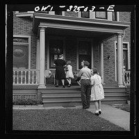 Cincinnati, Ohio. Bernard Cochran, a Greyhound bus driver, going into the house with his family. His wife and children drive down to the terminal to pick him up after work. Sourced from the Library of Congress.