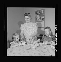 Cincinnati, Ohio. Mrs. Cochran, the wife of a Greyhound bus driver, giving the children Sunday breakfast. Sourced from the Library of Congress.