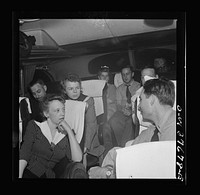 Passengers, who have struck up a friendship on a Greyhound bus enroute from Pittsburgh, Pennsylvania to Saint Louis, Missouri telling "moron" jokes. Sourced from the Library of Congress.