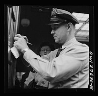 [Untitled photo, possibly related to: Chicago, Illinois. A bus driver punching tickets]. Sourced from the Library of Congress.