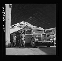 [Untitled photo, possibly related to: Indianapolis, Indiana. An old-type bus being boarded by passengers in the Greyhound bus terminal. The drivers call this type of bus a "dive bomber." These buses are about ten years old and have been completely rebuilt]. Sourced from the Library of Congress.