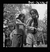 Bear Mountain, New York. Interracial activities at Camp Fern Rock, where children are aided by the Methodist Camp Service. Girls adjusting each others' packs for a hike. Sourced from the Library of Congress.