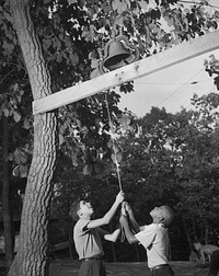 Southfields, New York. Interracial activities at Camp Nathan Hale, where children are aided by the Methodist Camp Service. Dinner bell. Sourced from the Library of Congress.