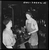 Pittsburgh, Pennsylvania. One of the women employees in the machine shop of the Greyhound garage working on a cylinder grinding machine. Sourced from the Library of Congress.