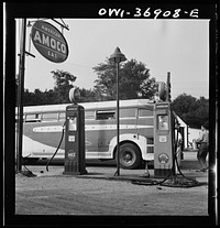 A Greyhound bus that has been stopped while the driver fills the water tank at a gas station on the road between Gettysburg and Pennsylvania. Sourced from the Library of Congress.