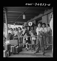 [Untitled photo, possibly related to: Pittsburgh, Pennsylvania. Passengers waiting for a bus to pull up to the loading platform at the Greyhound bus terminal]. Sourced from the Library of Congress.