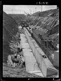 Columbia Steel Company at Geneva, Utah. Constructing a water intake tunnel for a new steel plant which will make important additions to the vast amount of steel needed for the war effort. Sourced from the Library of Congress.