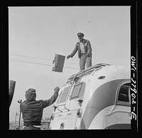 A Greyhound bus trip from Louisville, Kentucky, to Memphis, Tennessee, and the terminals. Loading a bus that carries baggage on the top. Chattanooga. Sourced from the Library of Congress.