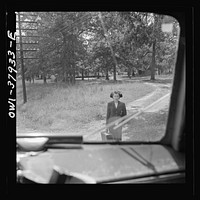 A Greyhound bus trip from Louisville, Kentucky, to Memphis, Tennessee, and the terminals. Girl waiting for bus by road's edge. Sourced from the Library of Congress.