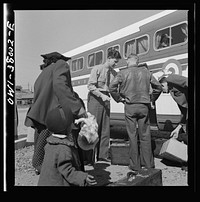 A Greyhound bus trip from Louisville, Kentucky, to Memphis, Tennessee, and the terminals. A bus driver checking baggage at small town in Tennessee. Sourced from the Library of Congress.