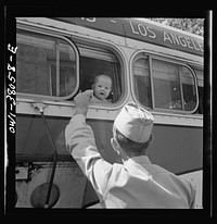 Bus trip from Knoxville, Tennessee to Washington, D.C. Soldier saying goodbye to his wife and child at small town in Tennessee. Sourced from the Library of Congress.