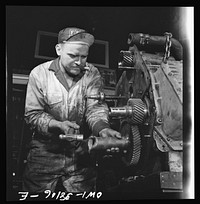 Bus trip from Knoxville, Tennessee, to Washington, D.C. Mechanic rebuilding bus motor at the garage of the Tennesse Coach Company in Knoxville. This is done every 100,000 miles. Sourced from the Library of Congress.