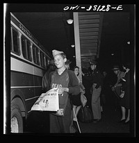 Bus trip from Knoxville, Tennessee, to Washington, D.C. Newsboy at Knoxville bus terminal. Sourced from the Library of Congress.
