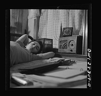 Washington, D.C. A radio is company for this girl in her boardinghouse room. Sourced from the Library of Congress.