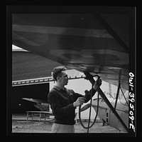 [Untitled photo, possibly related to: Frederick, Maryland. Returning from a practice flight at Stevens Airport, Walter Spangenberg, a student at Woodrow Wilson High School, ties down his plane]. Sourced from the Library of Congress.