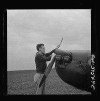 [Untitled photo, possibly related to: Frederick, Maryland. Walter Spangenberg, a student at Woodrow Wilson High School, spinning the propeller for a fellow student at the Stevens Airport]. Sourced from the Library of Congress.