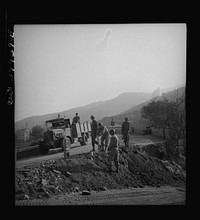 British equipment and troops repairing Sicilian roads demolished by the Germans. Sourced from the Library of Congress.