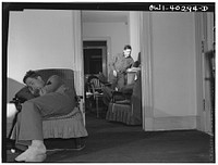 Washington, D.C. Servicemen who must wait several hours between trains sleeping in one of the lounges at the United Nations service center. Sourced from the Library of Congress.