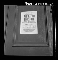 [Untitled photo, possibly related to: A sign in front of Woodrow Wilson High School on the day when number four ration books were issued]. Sourced from the Library of Congress.