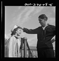 Washington, D.C. A Woodrow Wilson High School student, now in the U.S. Navy, talking to a girl. Sourced from the Library of Congress.